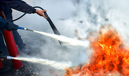 fire extinguishers being used to put our a fire