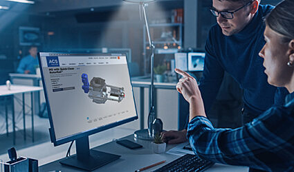 Two technical specialists looking at a screen with the Quick-Clean with RotorRail Valve
