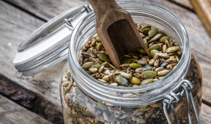 A mason jar filled with assorted seeds