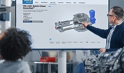 Presenter pointing to a screen with a 3D image of a Quick-Clean rotary valve