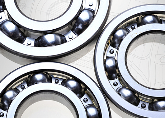 Three rotary valve bearings on a background of white schematics