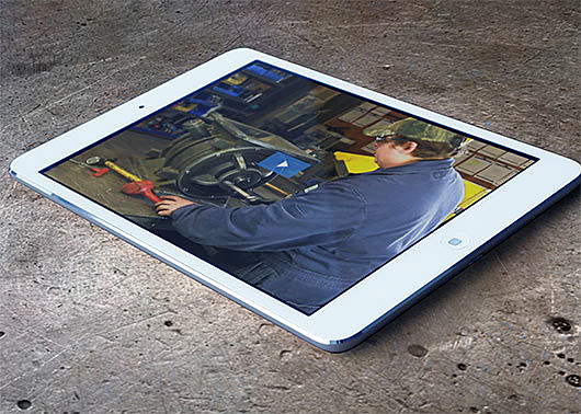 Tablet with video image of a technician assembling a rotary airlock valve.