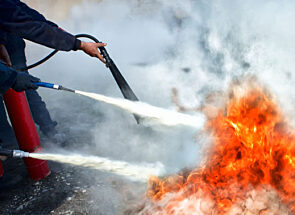 fire extinguishers being used to put our a fire