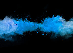 blue dust dispersing in a black background