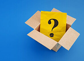 A yellow envelope with a question mark on the cover inside a box