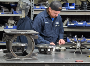 An ACS Valves technician working on a disassembled rotary airlock valve